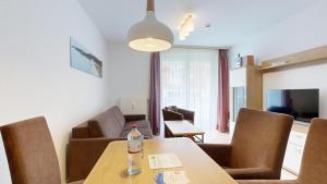 a living room with a table with a bottle on it at Appartementhaus Binzer Sterne 09 in Binz