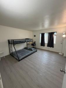 a room with two bunk beds and a wooden floor at Spring Training Special Comfy 3 Bedroom in Phoenix