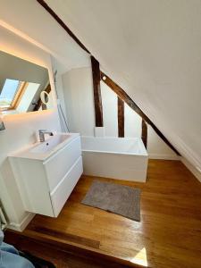 a bathroom with a sink and a bath tub at Duplex château de Versailles - 30 min de Paris in Versailles +27 photos