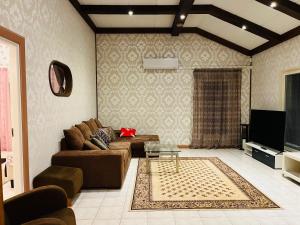 a living room with a couch and a tv at Lake Suite Family in Lahti