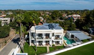 an aerial view of a house with a swimming pool at Palm View Suites in Kourouta