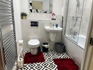 a bathroom with a toilet and a sink and a shower at Prime Location - Apt - Stay 4 - Lakeside - Parking in Grays Thurrock +8 photos