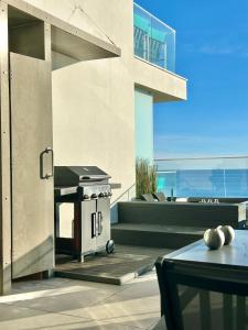 a outdoor kitchen with a grill on a patio at Feel So Good Apartment with Sea View Hot Tub in Sesimbra