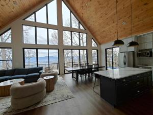a large kitchen and living room with large windows at Cliff's View Mountain Retreat in Luray