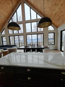 a living room with large windows and a table and chairs at Cliff's View Mountain Retreat in Luray +107 photos