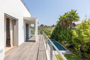 a wooden walkway leading to the balcony of a house at FRGK Luxury Two-Storey Villa with Pool & Rooftop Peaceful Setting Lord Brougham in Cannes