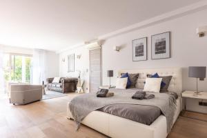 a white bedroom with a large bed and a living room at FRGK Luxury Two-Storey Villa with Pool & Rooftop Peaceful Setting Lord Brougham in Cannes +27 photos