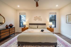 a bedroom with a large bed with two dressers and two windows at Cliff's View Mountain Retreat in Luray