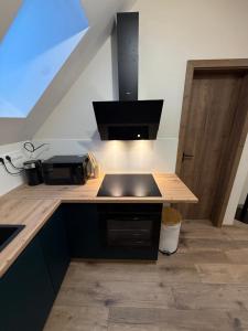 a kitchen with a counter with a sink and a stove at Apartman Mia 5 in Liptovský Mikuláš