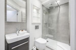 a bathroom with a sink and a toilet and a shower at Roomspace Serviced Apartments - The Quadrant in Richmond upon Thames +12 photos