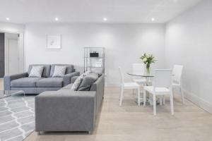 a living room with a couch and a table at Roomspace Serviced Apartments - The Quadrant in Richmond upon Thames