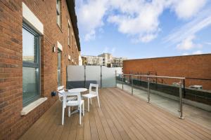 a balcony with a table and chairs on a building at Roomspace Serviced Apartments - The Quadrant in Richmond upon Thames