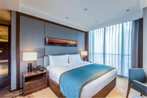 Postel nebo postele na pokoji v ubytování Oakwood Residence Damei Beijing