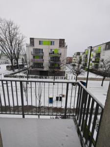 a balcony of a building with snow on the ground at Juniper 3 Business in Kecskemét