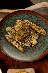 a plate of food on a wooden table at Manta Project in Morrillo