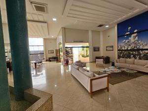 a large living room with couches and a table at Solar Hotel Luis Eduardo Magalhães in Luís Eduardo Magalhães