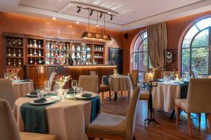 a restaurant with tables and chairs in a room at Palais Mirage d'Atlas, Hôtel & Spa in Marrakesh