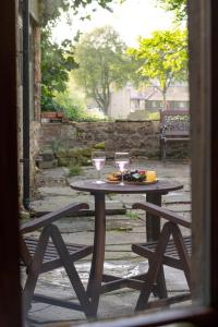 a wooden table with two wine glasses on it at 2 Bed in Settle oc-ds1038 in Settle +9 photos