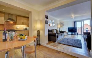 a kitchen and living room with a table and a couch at 2 Bed in Woolacombe oc-narr9 in Woolacombe