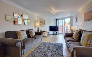 a living room with two couches and a television at 2 Bed in Woolacombe oc-narr9 in Woolacombe