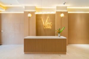 a lobby with a sign that reads vibe motel at Vibe Hotel Managed By Nicecy in Ho Chi Minh City