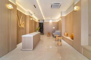 a lobby of a store with a reception desk and a toilet at Vibe Hotel Managed By Nicecy in Ho Chi Minh City