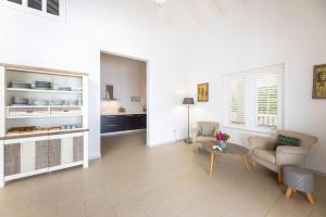 a living room with a couch and chairs and a table at Villa Ocho 8 - Coral Estate in Willibrordus