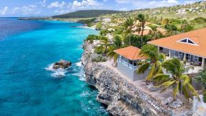 an aerial view of a resort and the ocean at Villa Ocho 8 - Coral Estate in Willibrordus