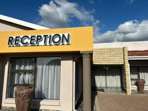 a store with a reception sign on a building at Bergsig Guesthouse in Bethlehem