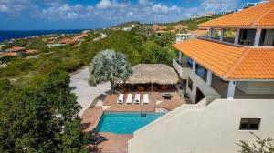 an aerial view of a house with a swimming pool at Scuba Dream Villa 519 - Coral Estate in Willibrordus