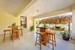 a room with a bar with stools and a large window at Scuba Dream Villa 519 - Coral Estate in Willibrordus