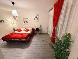 a bedroom with a bed and a desk in it at Les Trois koush in Courcouronnes