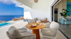 a dining room with a view of the ocean at Villa Esmeraldas 1207 - Coral Estate in Willibrordus
