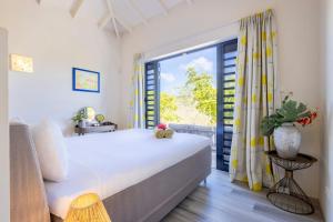 a bedroom with a large bed and a large window at Villa Esmeraldas 1207 - Coral Estate in Willibrordus