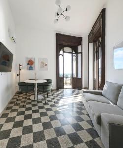 a living room with a couch and a table at TheSuperhost - Aquaria - Vista Mare in Crotone