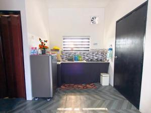 a kitchen with a sink and a counter top at White House Villa in Sekinchan