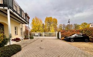 a car parked in the driveway of a house at Kungs Ferienwohnung 2 in Cottbus
