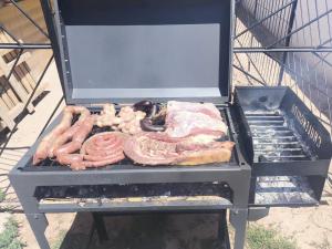 a grill with a bunch of meat on it at Luminares in Humahuaca