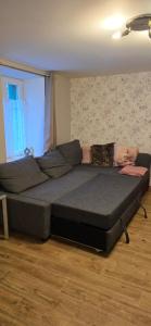 a large bed in a room with a window at La Maison Ôtrement in Martelange