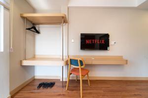 a room with a desk and a chair next to a wall at Vibe Hotel Managed By Nicecy in Ho Chi Minh City +72 photos