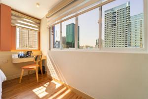 a room with a view of the city from a window at Vibe Hotel Managed By Nicecy in Ho Chi Minh City