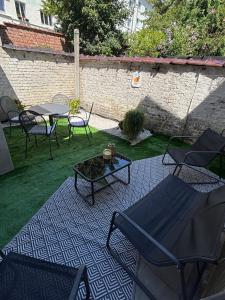 a patio with chairs and a table and a table and chairs at Modern apartment in Brussels, ground floor in Brussels