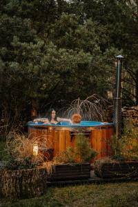 a woman in a hot tub in a garden at Willa tuŻur in Osie