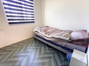 a bedroom with a bed on the floor at White House Villa in Sekinchan