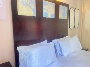 a bed with white pillows in a bedroom at Peaceful stays in Mapungubwe in Johannesburg +15 photos