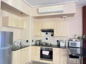 a kitchen with wooden cabinets and a stove top oven at Peaceful stays in Mapungubwe in Johannesburg