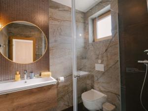 a bathroom with a shower and a toilet and a mirror at Holiday Home A'more Preko Ferienhaus in Preko Insel Ugljan by Interhome in Preko
