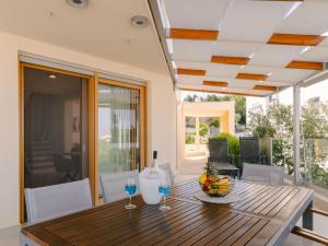a dining room with a wooden table with wine glasses at Holiday Home A'more Preko Ferienhaus in Preko Insel Ugljan by Interhome in Preko
