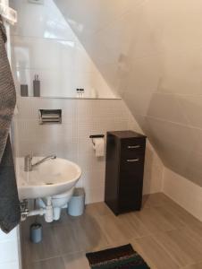 a small bathroom with a sink and a toilet at Widlakówka in Rzepiska