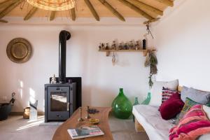 a living room with a couch and a wood stove at Luna Inn B&B in Corfu